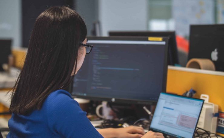 A member of the Envisage Technology team working at her laptop